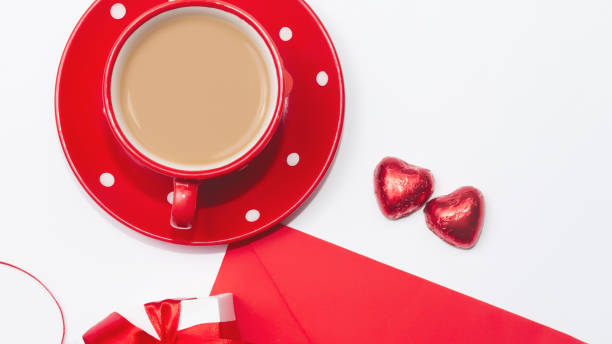 istock Beautiful Valentines composition of gift, Red envelope with blank white note mockup inside, chocolate heart shaped, coffee in Happy Valentines, Mothers and fathers day and love celebration concept. 1368192014