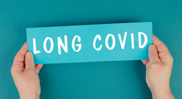 The words long covid are standing on a paper, health problems after Covid-19 disease stock photo