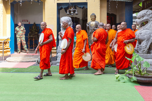 Colombo, Sri Lanka - February 5, 2020: Buddhist monks walk in a procession in front of the Gangaramaya Temple in Colombo