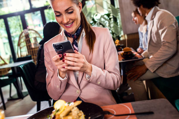 istock Businesswoman having lunch in restaurant. 1368194506