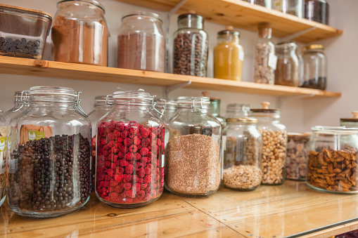 Close up of a glass jars full of sustainable goods in a zero waste store.