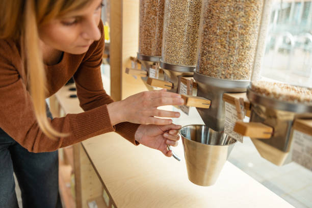 istock Close Up Of A Female Using A Cereal Dispenser In A Zero Waste Store 1368195164