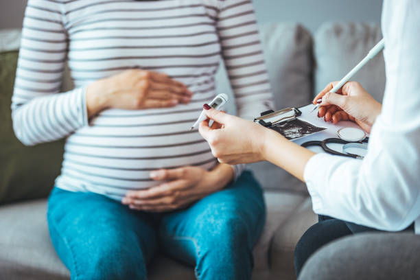 istock A pregnant woman during a routine check up with her doctor. 1368196248