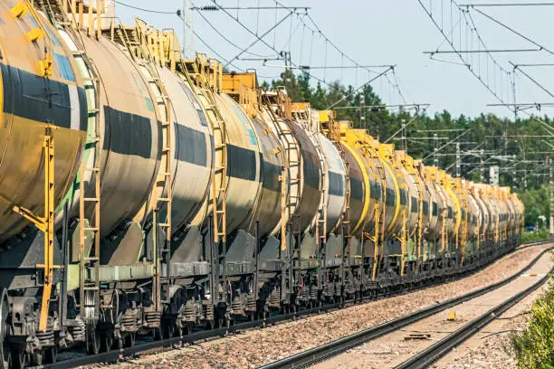 Scandinavia - trainload of petrochemical products in tank wagons being transported from Russia on Finnish Railways electrified mainline, ID & logos edited
