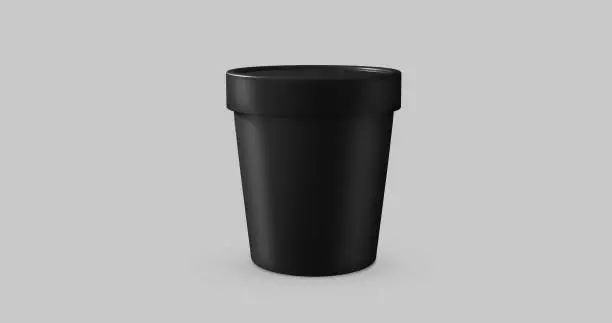 Photo of 3D white and black round container for ice cream, cream or yogurt. Perspective view isolated on gray background. Packaging mockup image.