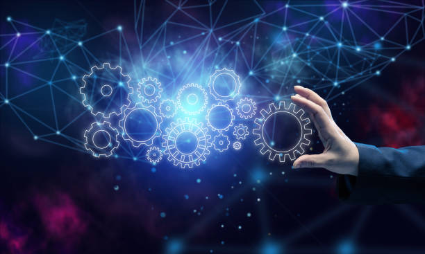 istock gear wheels and female hand on a blue background. Business structure precise work concept, team unification 1368197673