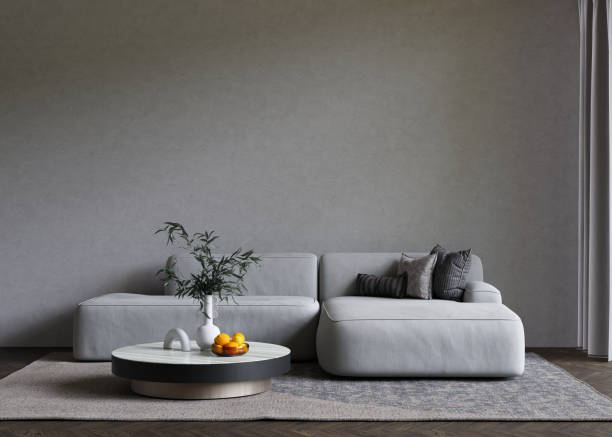 istock Minimalist gray interior with sofa and coffee table on the carpet. Big empty wall mock up. 3D render. 1368199485