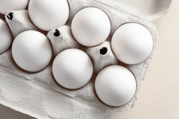 istock Part of a cardboard box with fresh white eggs, ingredient for cooking, baking, breakfast and Easter, high angle view from above, selected focus 1368200654