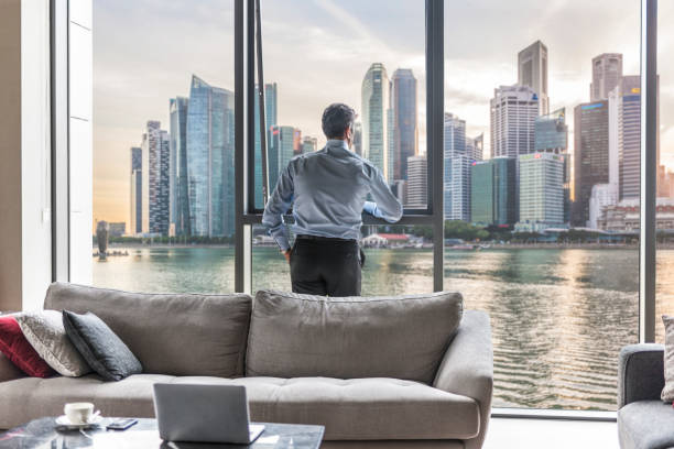 istock Businessman watching the city view in his office 1368200761