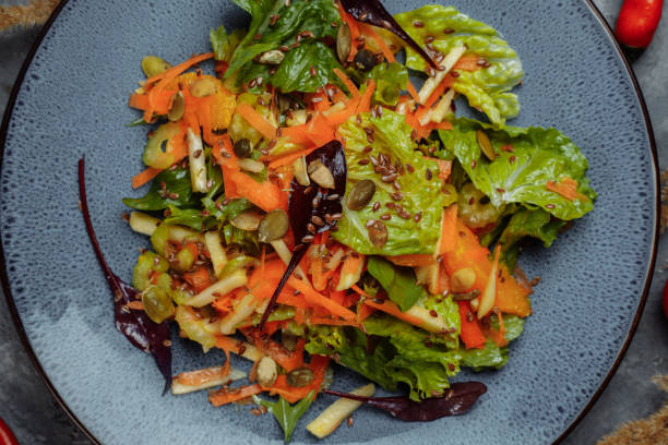 istock Sicilian salad with fennel, oranges, grapefruit and radicchio salad with balsamic dressing on a blue linen tablecloth. healthy summer italian food 1368201029