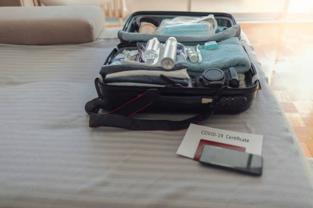 istock Suitcase packing for travel, COVID-19. 1368202074