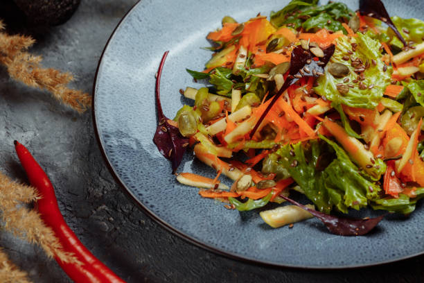 istock Sicilian salad with fennel, oranges, grapefruit and radicchio salad with balsamic dressing on a blue linen tablecloth. healthy summer italian food 1368202348
