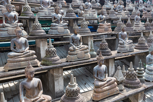Array of buddha statues in Gangaramaya buddist temple, Colombo, Sri Lanka.
