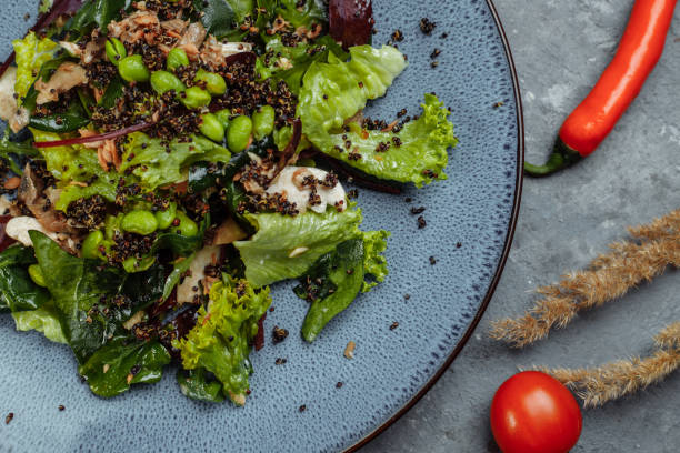 istock Fresh lamb lettuce salad with avocado, cucumber, salmon, cherry tomatoes. 1368204589