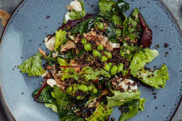 istock Fresh lamb lettuce salad with avocado, cucumber, salmon, cherry tomatoes. 1368205332
