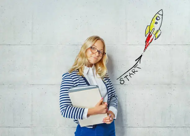 Photo of Studio shot of a glad female student in glasses with the books - get started with your studies