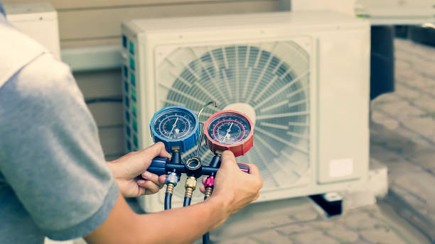 Air conditioner technician checks the operation of industrial air conditioners. stock photo