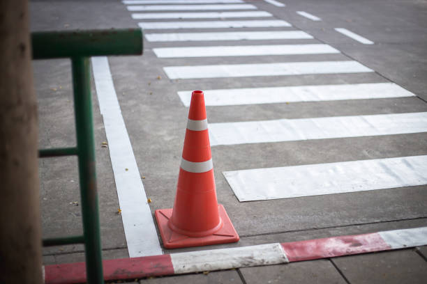 istock Orange traffic cones on cement road surface. 1368206859