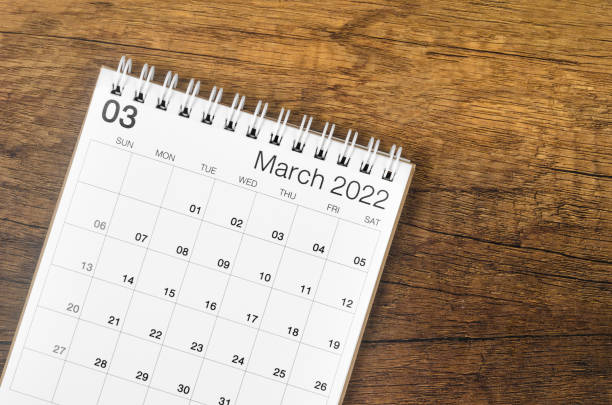 istock March 2022 desk calendar on wooden background. 1368206997