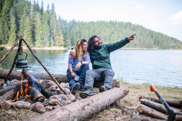 istock Young couple enjoying beautiful morning at camping. 1368207240