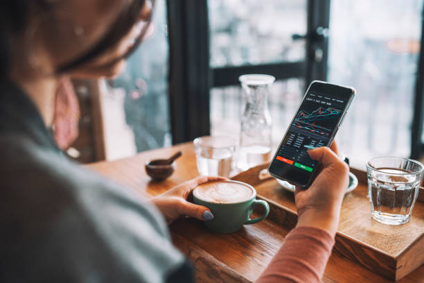 woman using smartphone buy cryptocurrency at a coffee shop, blockchain investment, decentralize and stock market concept. - aktiemarknad och börs bildbanksfoton och bilder