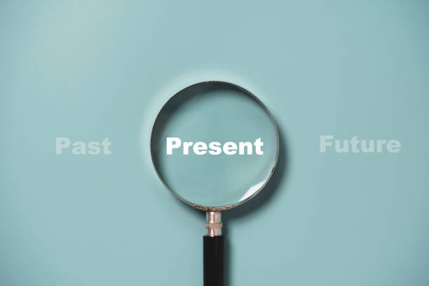istock Present wording inside of Magnifier glass on blue background for focus current situation , positive thinking mindset concept. 1368208338