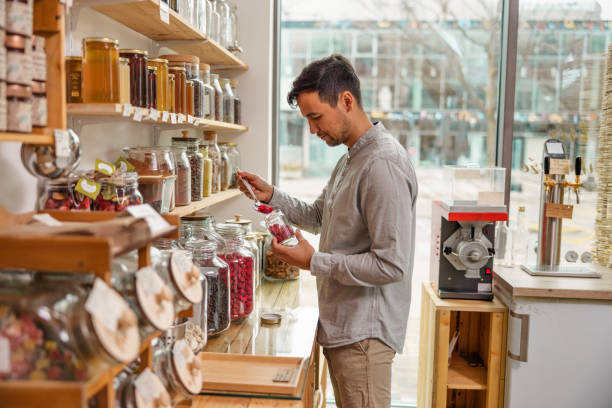 istock Male Costumer Refilling A Reusable Jar In A Sustainable Store 1368208492