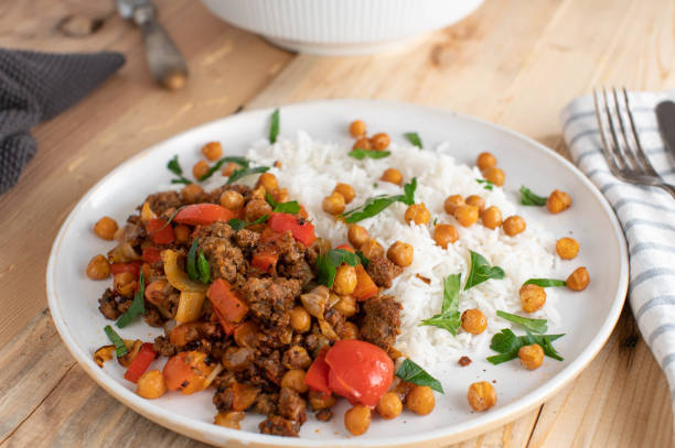 Stir fried ground beef with chick peas, vegetables and rice stock photo