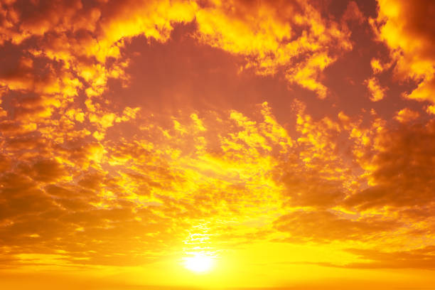 istock Blazing cloudy sky at sunset. Golden sunset sky 1368209913
