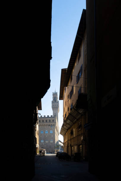 Palazzo Vecchio medieval building in Florence, Italy Florence, Italy. January 2022.  the view of the Palazzo Vecchio against the backdrop of a narrow alley in the city center Cosimo stock pictures, royalty-free photos & images