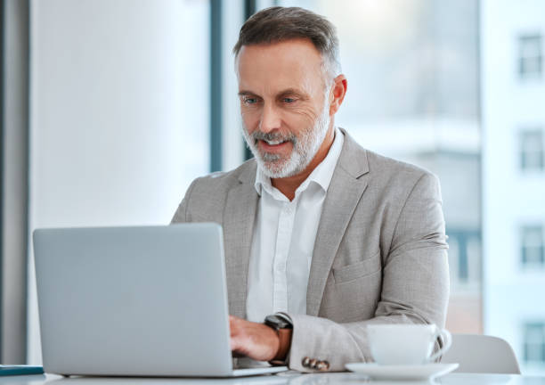 istock Shot of a mature man using a computer at work in a office 1368210458