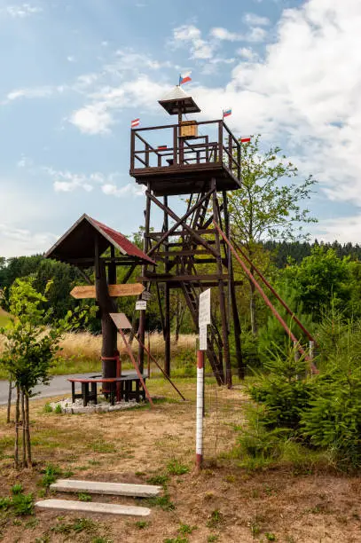 Photo of Lookout tower in small village Nová Ves u Kdyn, Sumava, Bohemian Forest, Böhmerwald, Czech Republic. Wooden signpost.