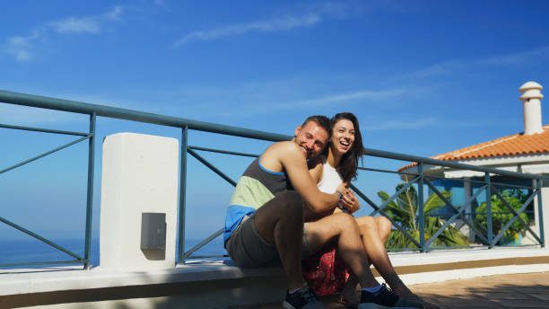 istock Couple on a patio with sea view. Hugging and having fun 1368212900