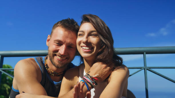 istock Couple on a patio with sea view. Hugging and having fun 1368212910