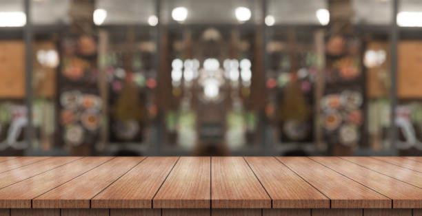 istock Empty wooden table top with lights bokeh on blur restaurant background. 1368214323