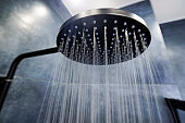Water running from a black rain shower head