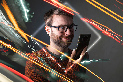 A man in the metaverse, confused, makes a stupid face, surrounded by futuristic lights and effects, while looking at his smartphone
