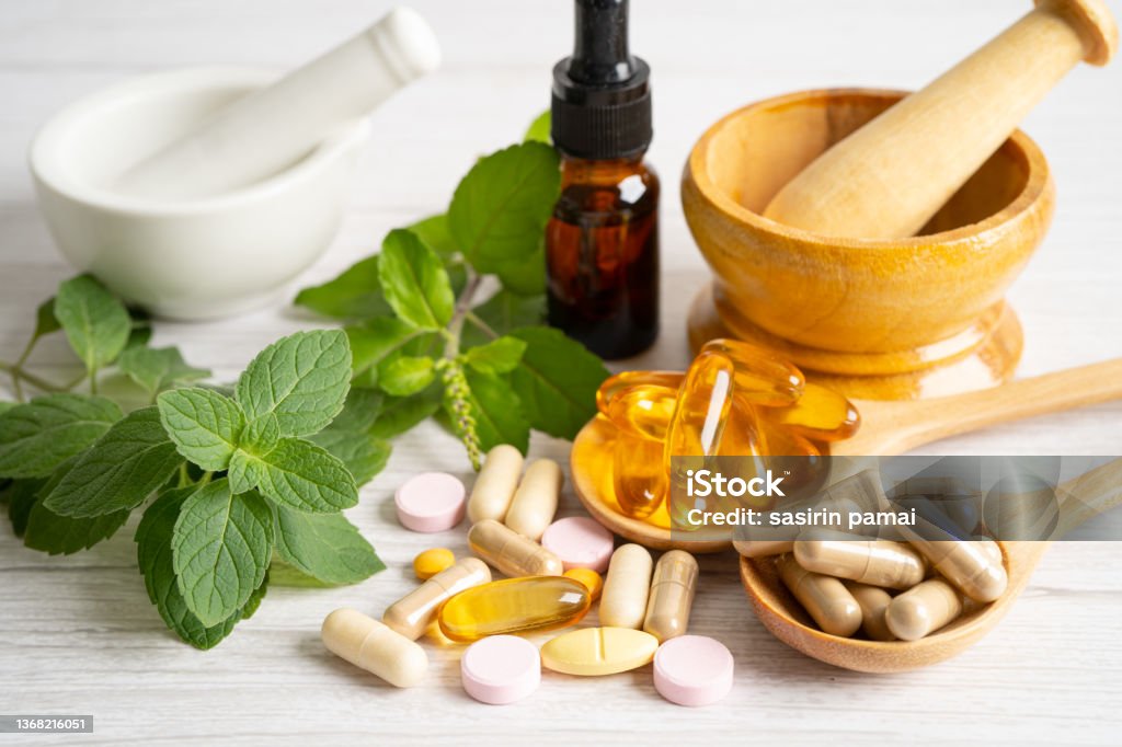 Alternative medicine herbal organic capsule with vitamin E omega 3 fish oil, mineral, drug with herbs leaf natural supplements for healthy good life. Nutritional Supplement Stock Photo
