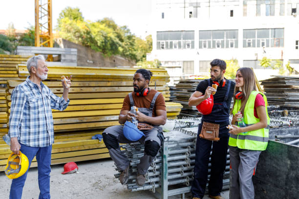 istock Multicultural Group of Building Workers are Taking a Rest and Refreshing with Food and Drink. 1368216491