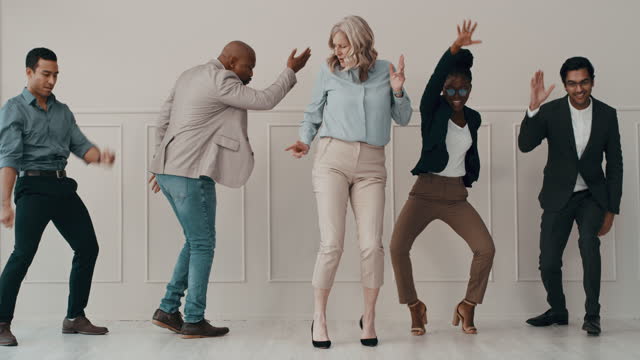 4k video footage of a diverse group of businesspeople dancing in the office