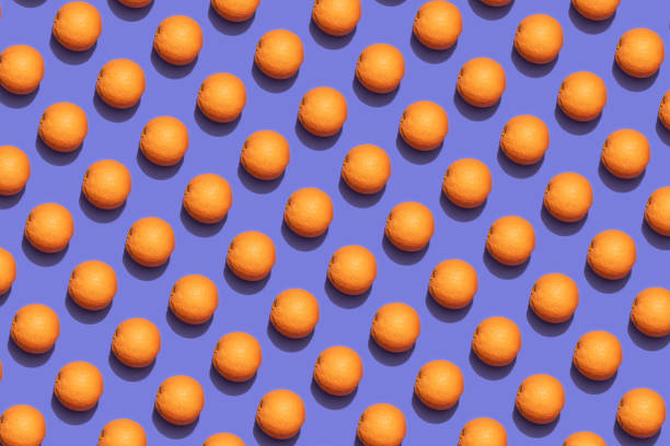 istock Fruit oranges in checkered pattern on violet background. Violet and orange colors background from fruity oranges. Demonstrating very peri, color of 2022 year. 1368217250