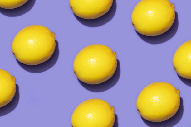 istock Fruit lemon in checkered pattern on violet background. Violet and yellow colors background from fruity lemon. Demonstrating very peri, color of 2022 year. 1368217314