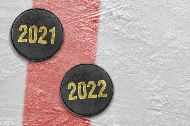 istock Two pucks on a hockey arena with a red line 1368217953