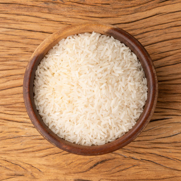 istock Raw white rice in a bowl over wooden table 1368218602