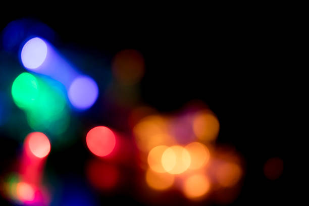 Defocused Christmas lights with beautiful lights bokeh. Black background with space for copy.