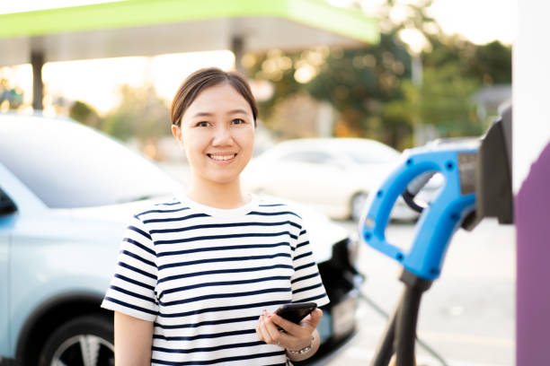 istock Woman charging her electric car - EV 1368219472
