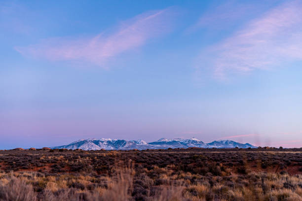 Sunset Dusk Photo of the La Salle Mountains from Moab with Copy Space Low Angle Telephoto Sunset shot of the La Salle Mountain peaks near Moab in Southwest Utah. la sal mountains stock pictures, royalty-free photos & images
