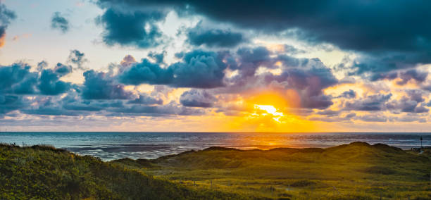 Sunset by the sea with golden sunrays