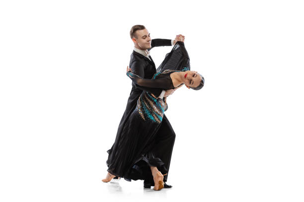 istock Flexible young couple dancing tango isolated on white studio background. Artists in black stage costumes 1368225746