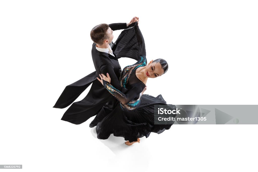 Top view portrait of young artistic couple dancing waltz isolated over white studio background Top view portrait of young artistic couple dancing waltz isolated over white studio background. Models in beautiful stage costumes. Concept of art, beauty, grace, action, emotions. Copy space for ad Tango - Dance Stock Photo